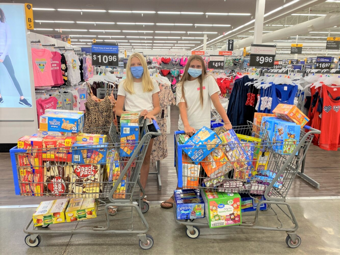 shoppers with carts of food