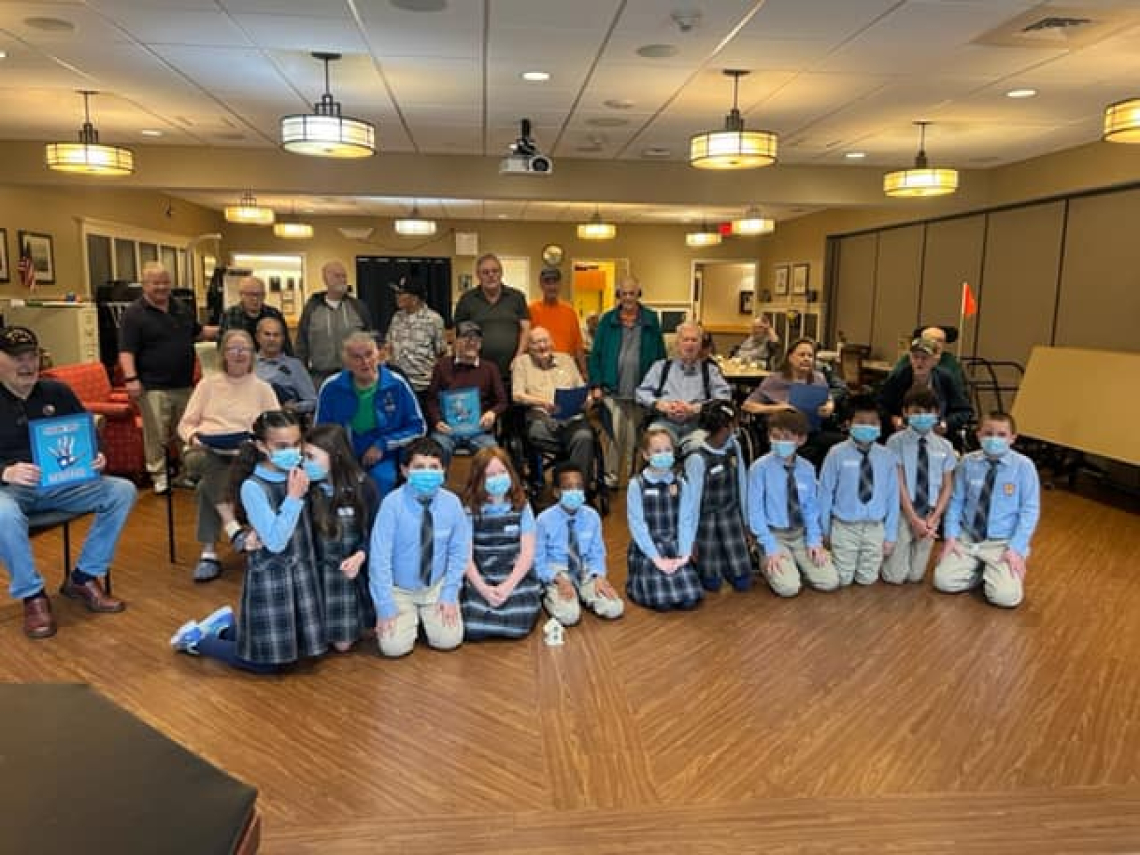 Holy Cross students in South Portland meet their veteran pen pals. 