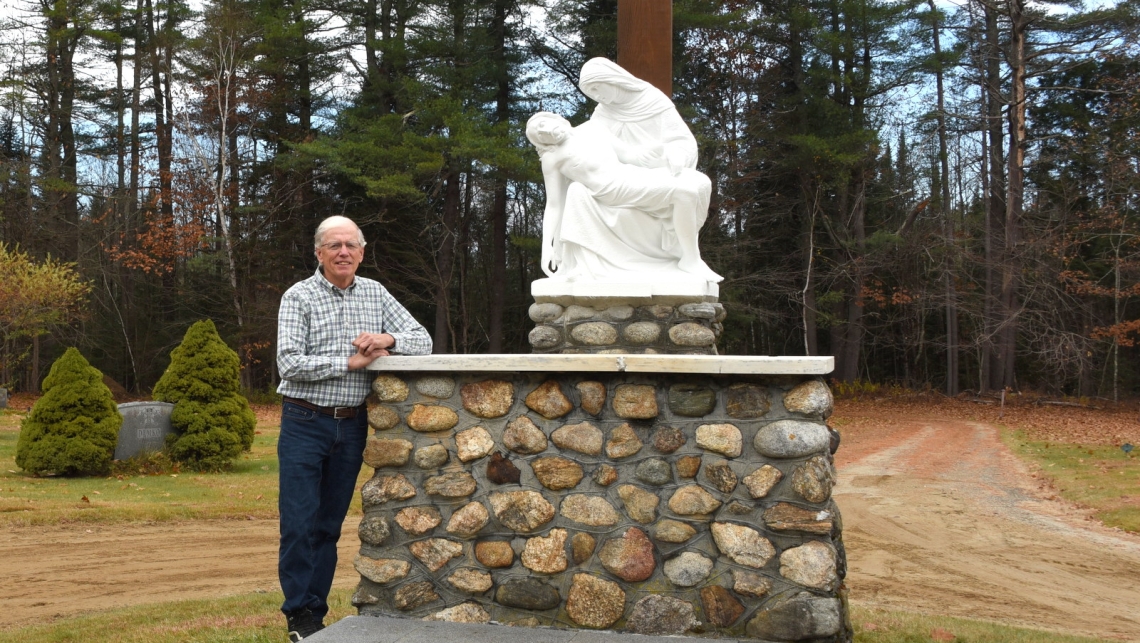 George Janosco standing next to the pietà