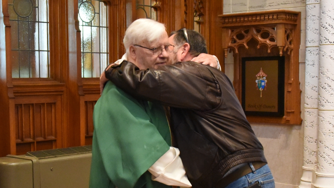 Brother Irenee Richard receives a congratulatory hug.