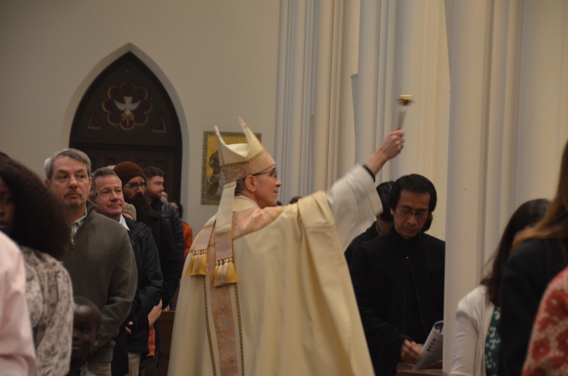 Bishop blesses congregation with holy water