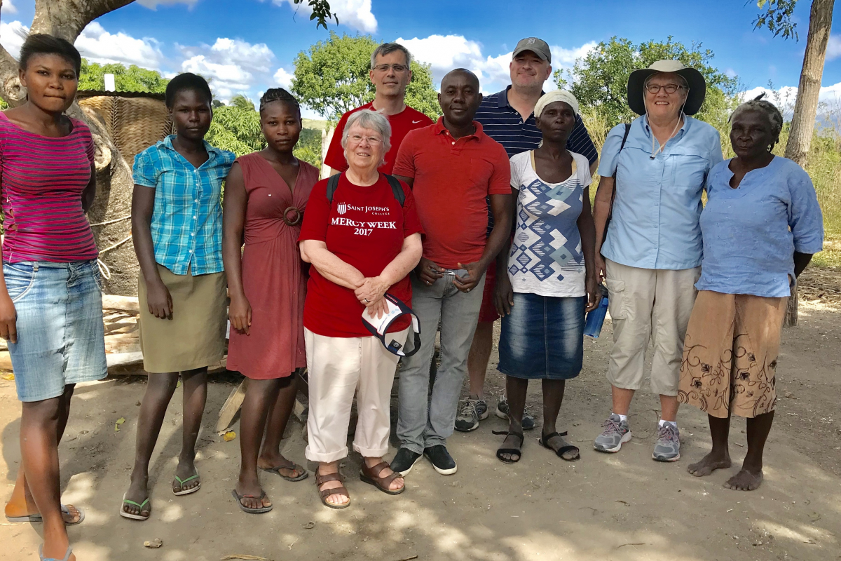 Sister Dale Jarvis, RSM with caseworkers and a family in Haiti.