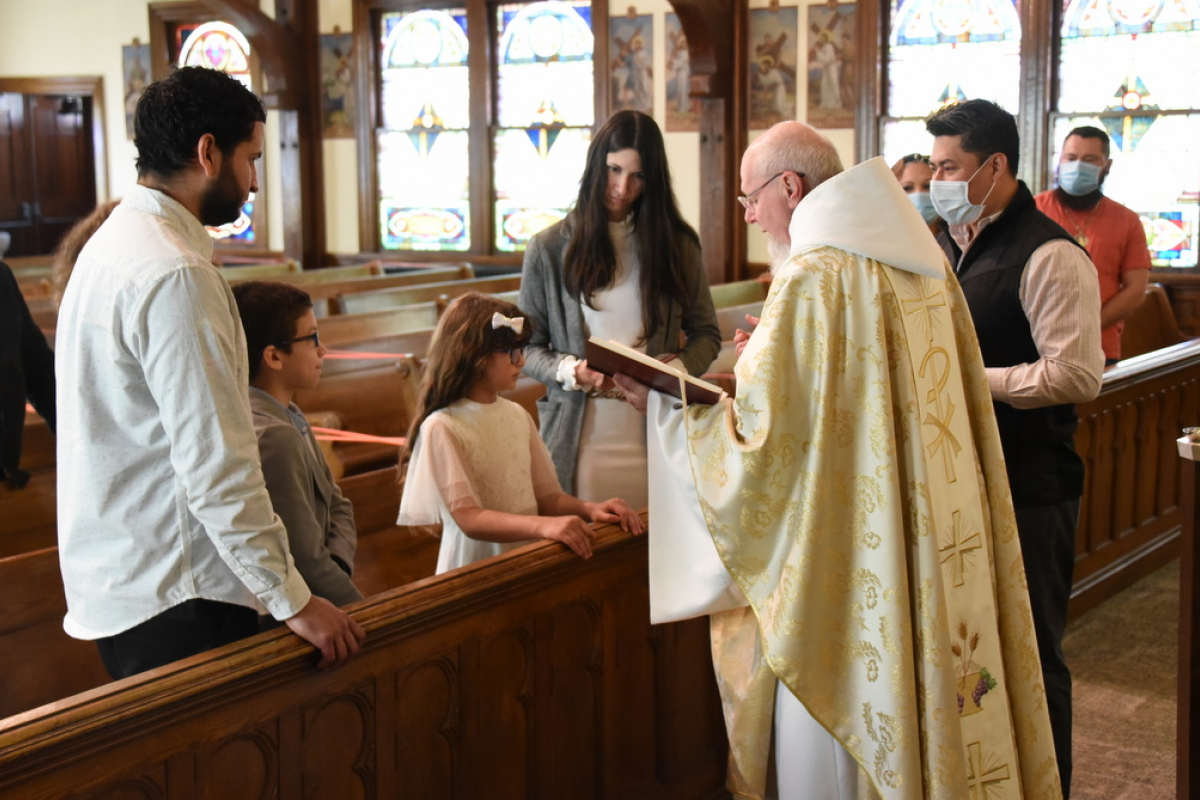 Father Sevigny baptizes 8-year-old Sylkia.
