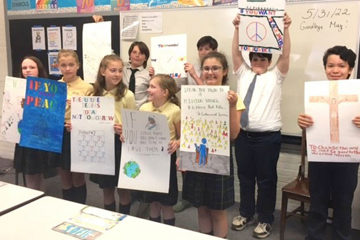 Students holding up posters