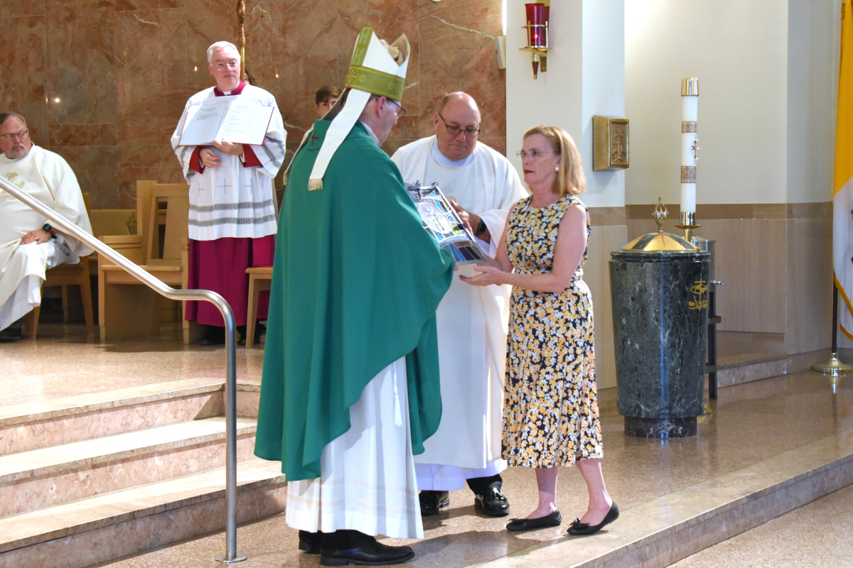The bishop presents the Matthew 25 Award to Barbara Russell.