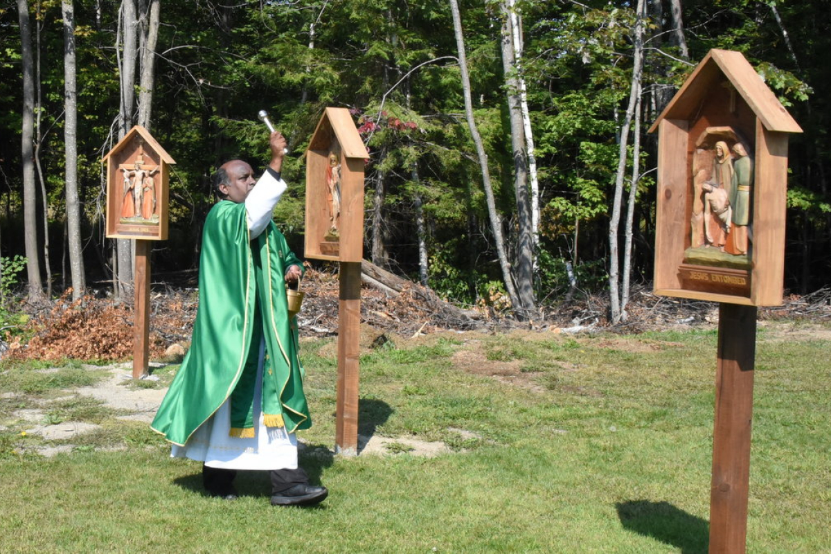 Father Dominic Savio blesses the Stations of the Cross.