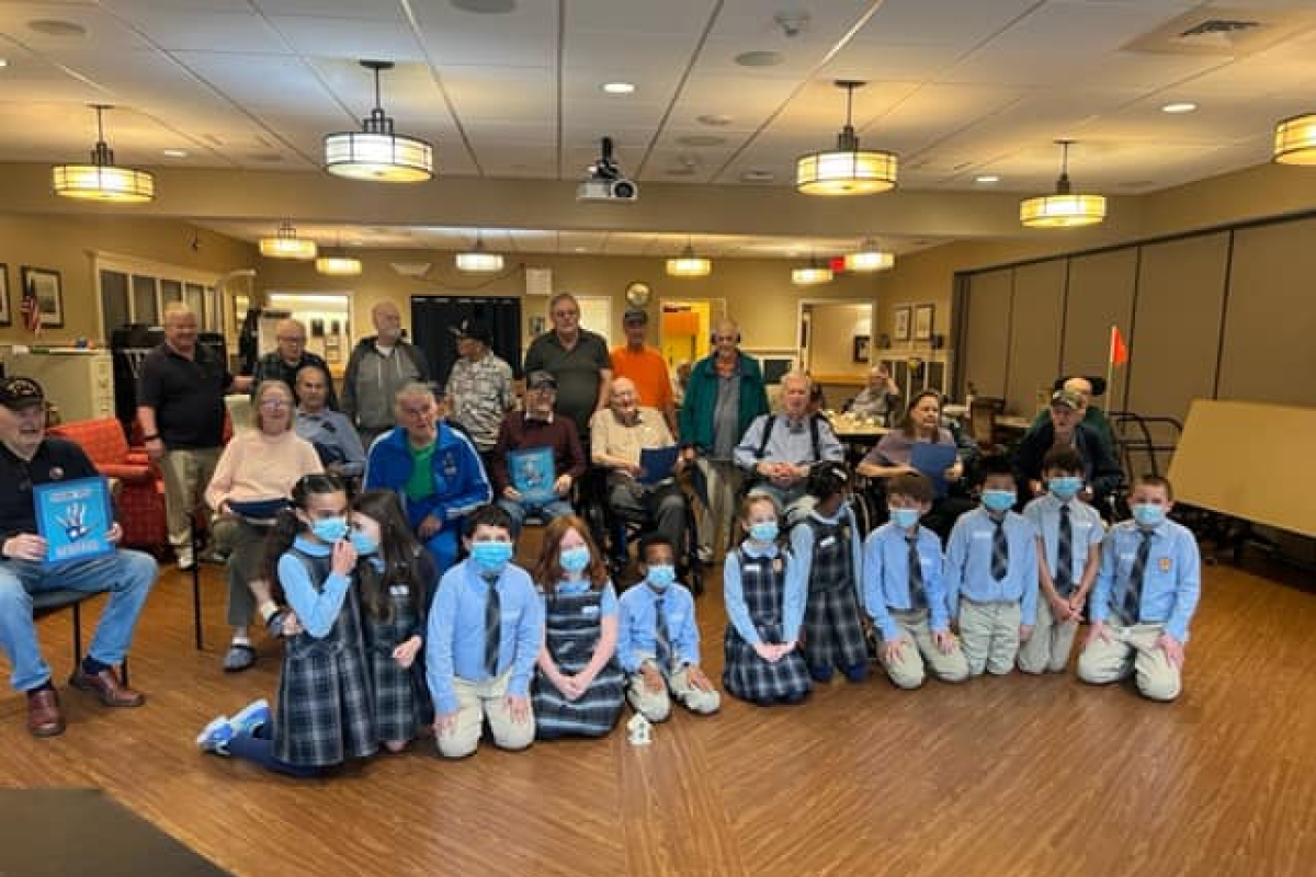 Holy Cross students in South Portland meet their veteran pen pals. 