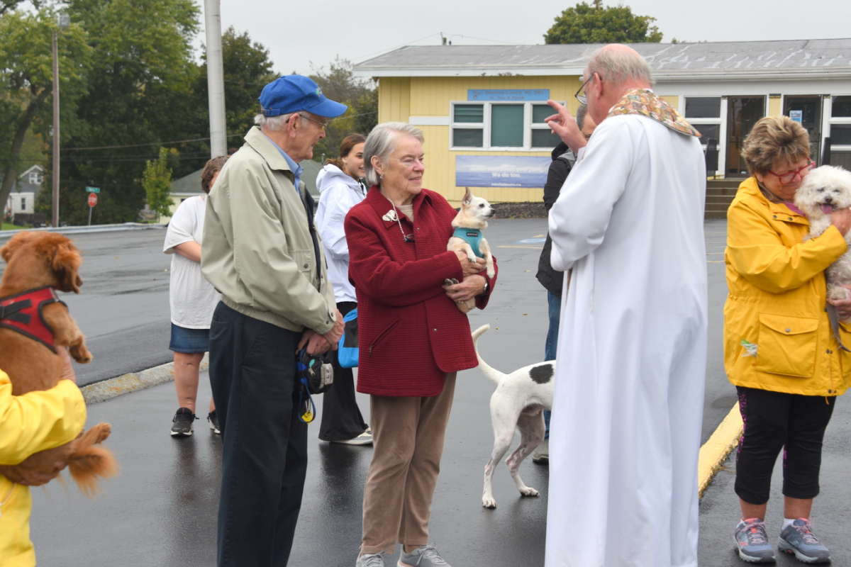 Father Conley blessing a dog.