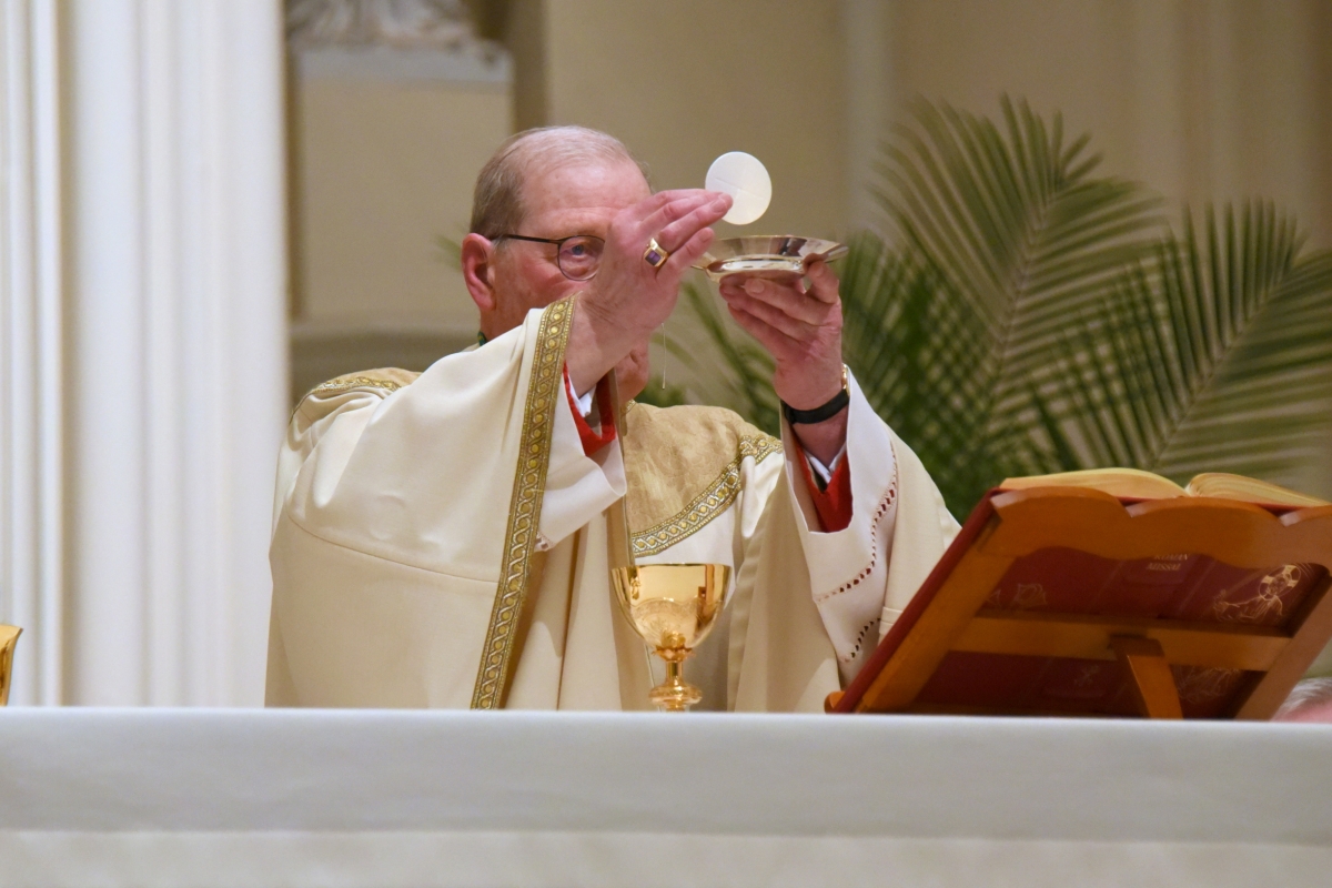 Bishop Deeley holding up the Eucharist