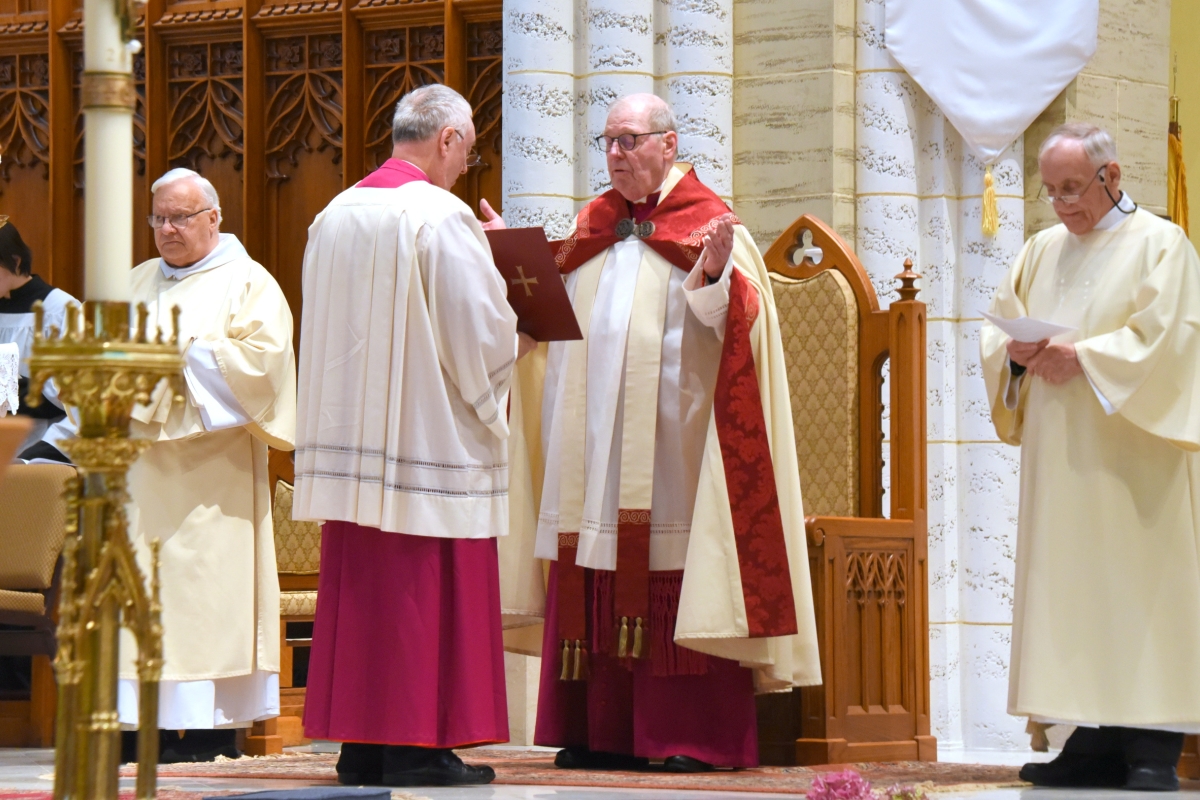 Bishop Deeley prays with Msgr. Marc Caron, Deacon Denis Mailhot, and Brother Irenee Richard, OP