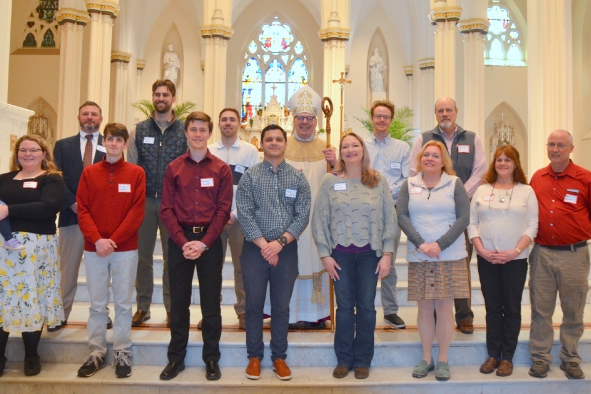Neophytes pose with Bishop Deeley
