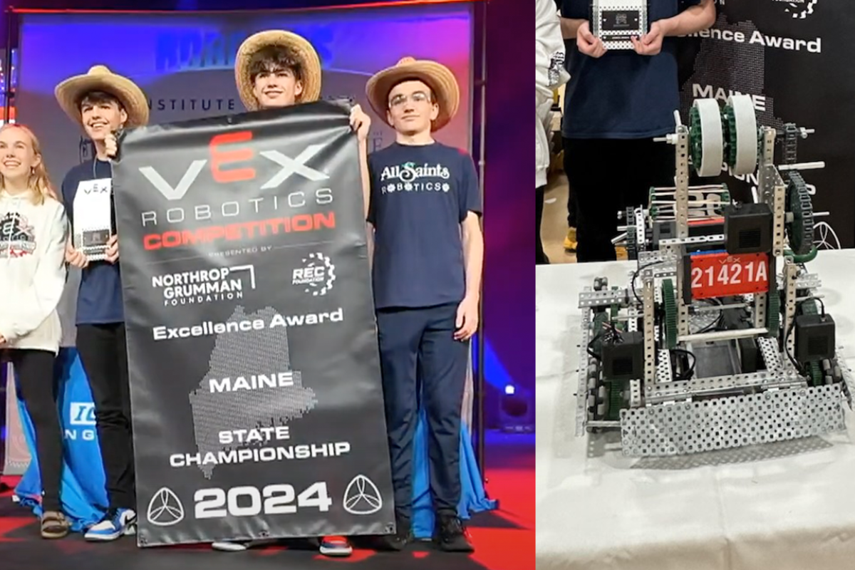 Students with banner and winning robot
