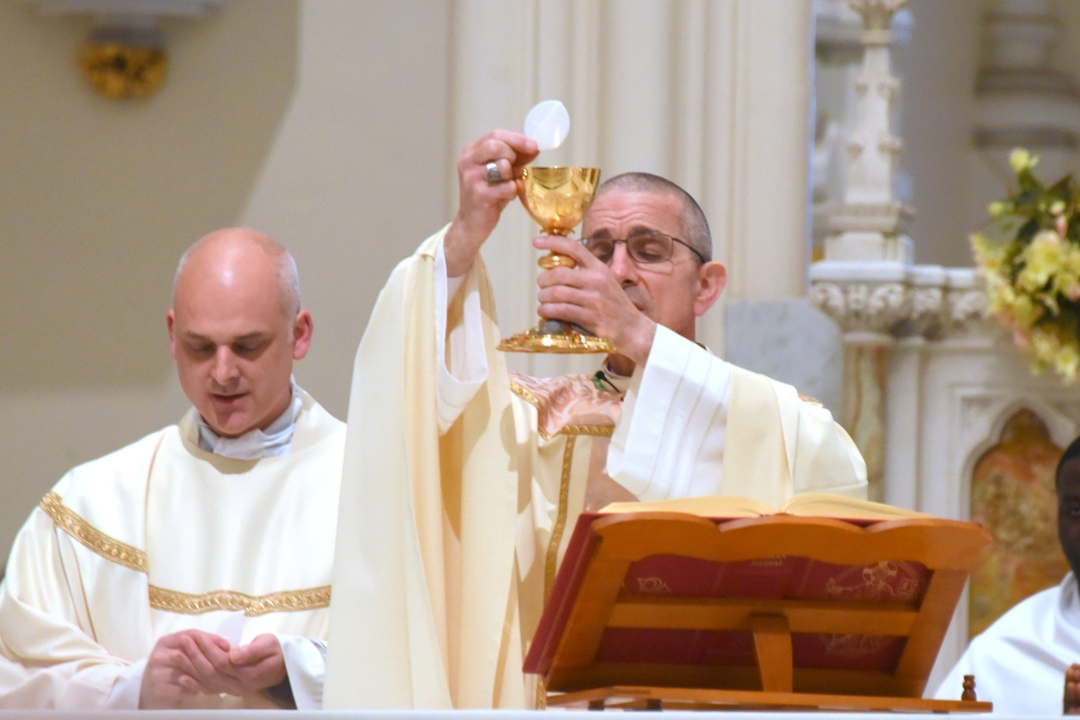 Bishop James Ruggieri holds up the host during the Liturgy of the Eucharist.