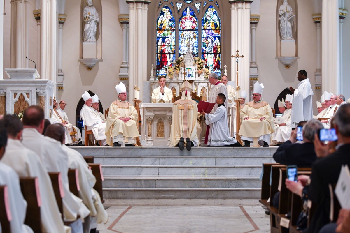 Cardinal O'Malley presents Bishop Ruggieri with the Book of the Gospels, a view from the back of the church.