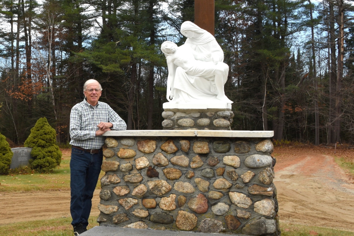 George Janosco standing next to the pietà