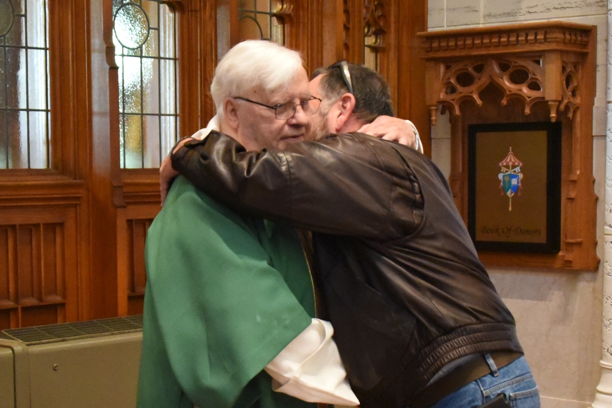 Brother Irenee Richard receives a congratulatory hug.