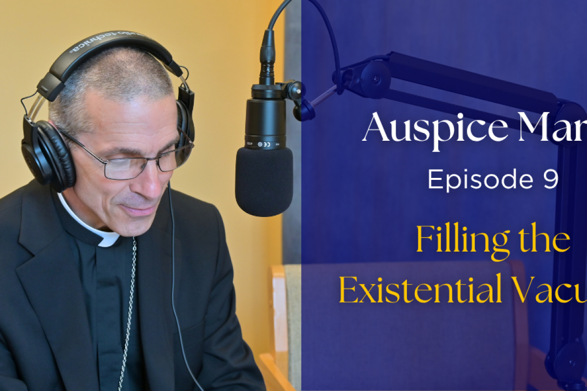 Bishop Ruggieri sitting in front of a microphone. text: "Auspice Maria, Episode 9 filling the existential vacuum"