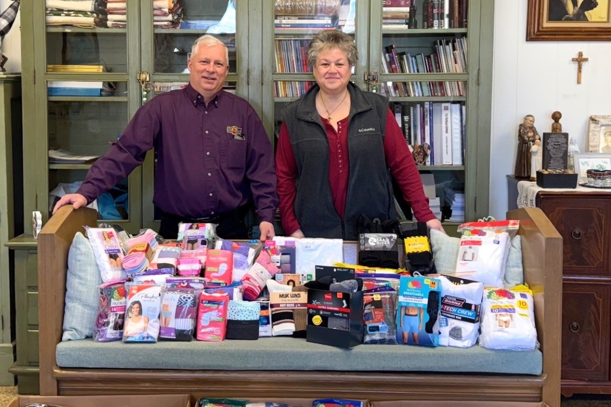 Jail ministry volunteers behind donated items.